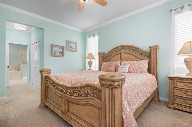 carpeted bedroom featuring ensuite bath, ceiling fan, a closet, and crown molding