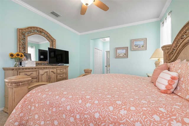 bedroom featuring ceiling fan, crown molding, and a closet