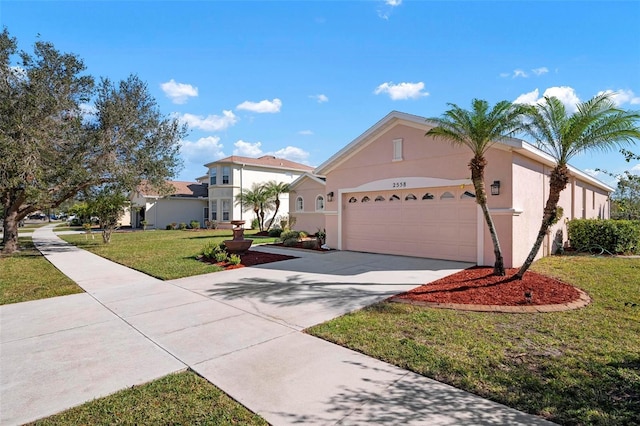 view of front of property featuring a garage and a front lawn