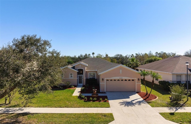 single story home featuring a garage and a front lawn