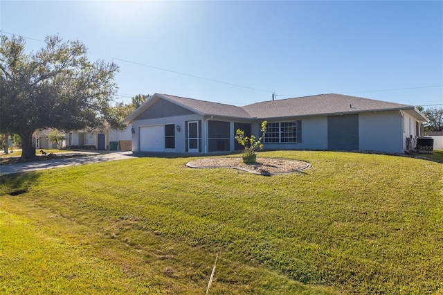 view of front of house with central AC, a front lawn, and a garage