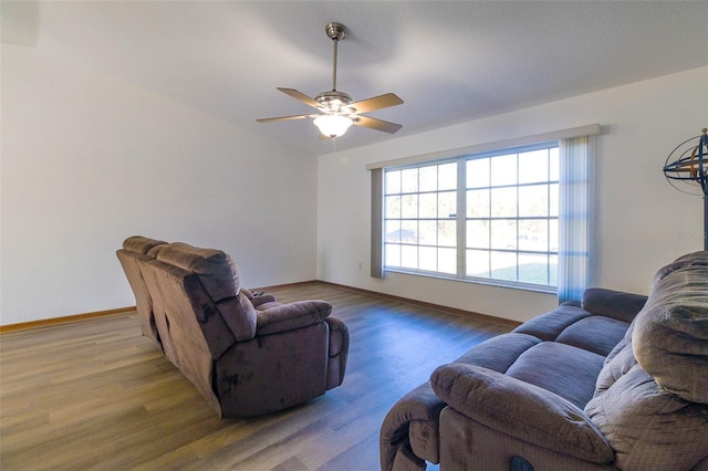 living room with wood-type flooring and ceiling fan