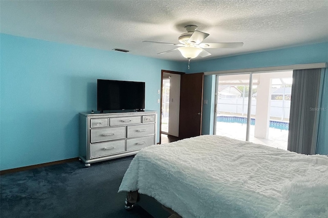 bedroom featuring dark colored carpet, a textured ceiling, access to exterior, and ceiling fan