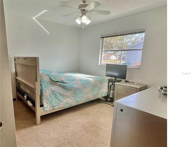 bedroom featuring ceiling fan and light carpet