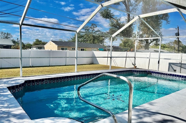 view of pool with glass enclosure