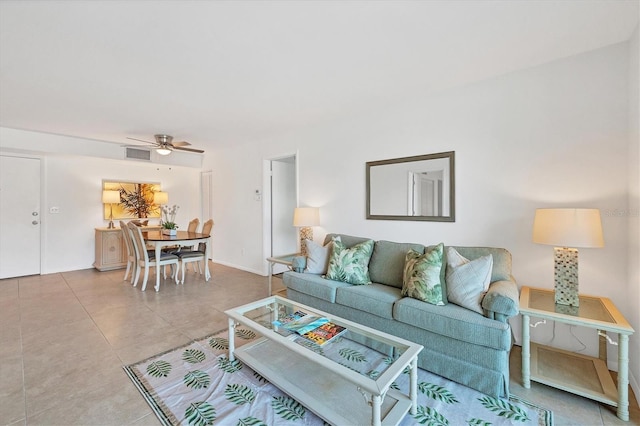 living room featuring tile patterned flooring and ceiling fan