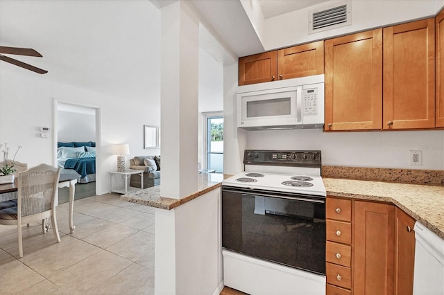 kitchen featuring kitchen peninsula, light stone counters, white appliances, ceiling fan, and light tile patterned flooring