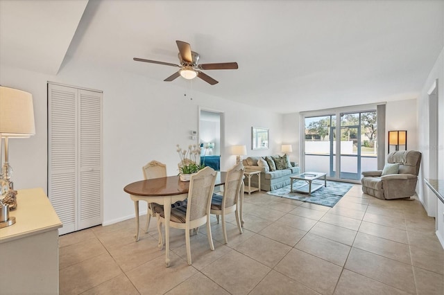 dining area with french doors, ceiling fan, and light tile patterned flooring