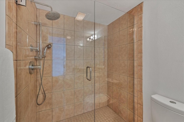 bathroom featuring an enclosed shower and toilet