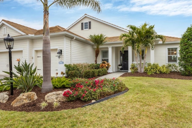 view of front facade featuring a front yard and a garage