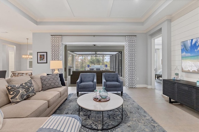 tiled living room featuring ornamental molding and an inviting chandelier