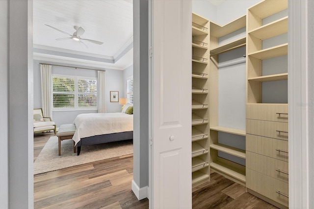 bedroom with ceiling fan, crown molding, and hardwood / wood-style floors