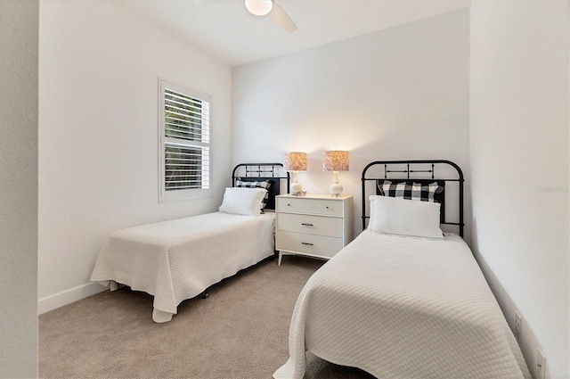 bedroom featuring light carpet and ceiling fan