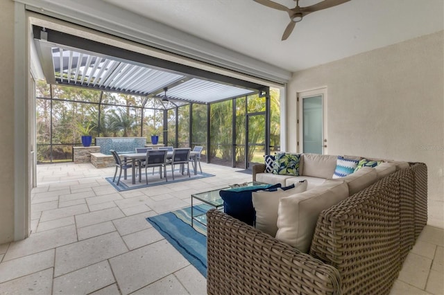 view of patio with ceiling fan, an outdoor living space, and a lanai