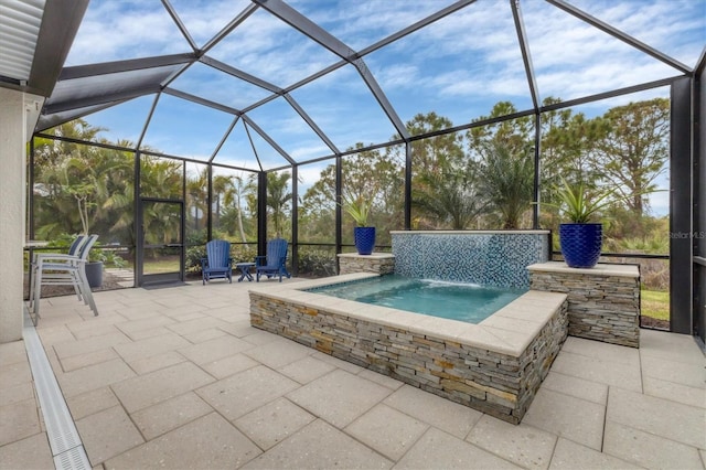 view of patio / terrace featuring pool water feature, glass enclosure, and a hot tub