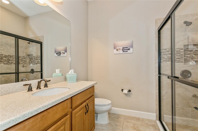 bathroom with a shower with door, vanity, and tile patterned flooring