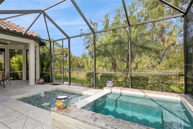 view of swimming pool with a lanai and a patio