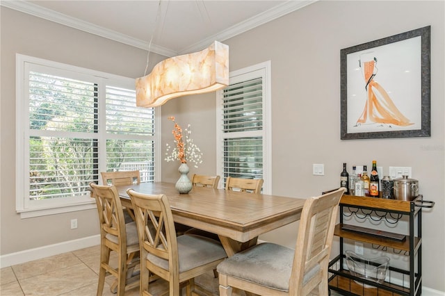 dining room with crown molding and light tile patterned flooring