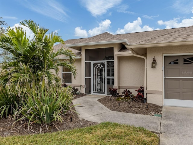 view of exterior entry featuring a garage