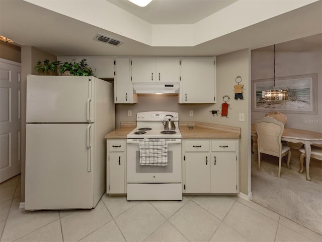 kitchen featuring white cabinetry, a notable chandelier, decorative light fixtures, white appliances, and light colored carpet