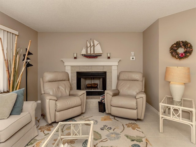 tiled living room with a textured ceiling and a tiled fireplace