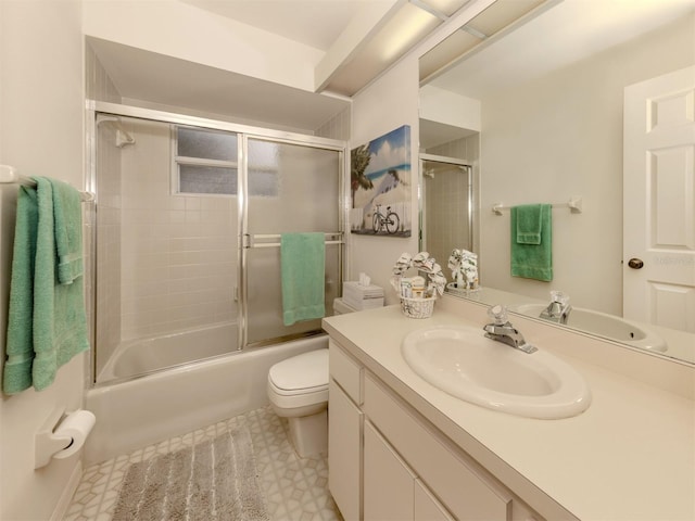 full bathroom with combined bath / shower with glass door, vanity, and toilet