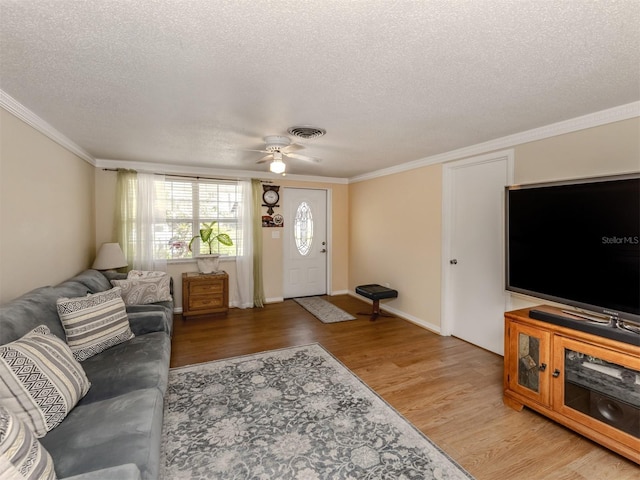 living room featuring a textured ceiling, ceiling fan, crown molding, and hardwood / wood-style floors