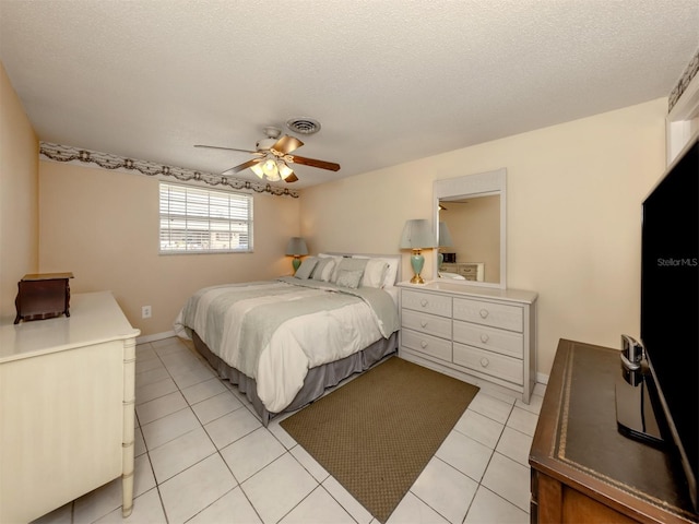 tiled bedroom with a textured ceiling and ceiling fan