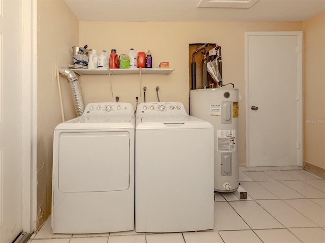 laundry room featuring washer and dryer, water heater, and light tile patterned floors