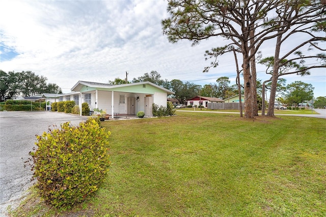 view of front of property with covered porch and a front lawn