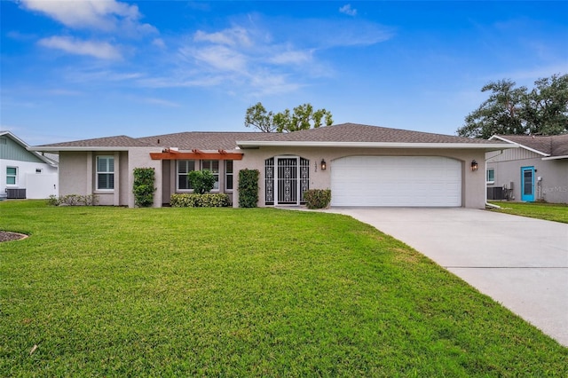 single story home with a front yard, a garage, and central AC unit