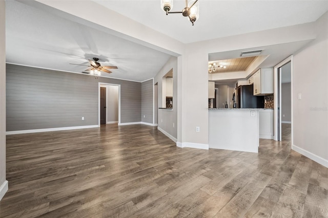 unfurnished living room featuring hardwood / wood-style flooring and ceiling fan