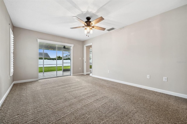 carpeted spare room with ceiling fan