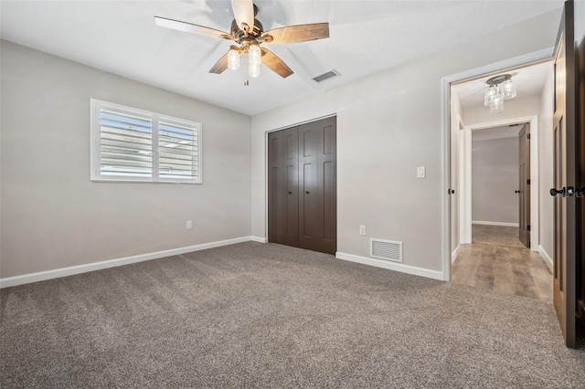 unfurnished bedroom featuring carpet flooring, ceiling fan, and a closet