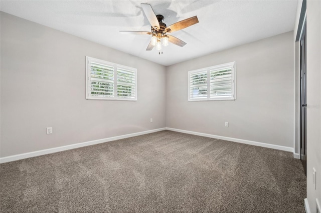 carpeted empty room featuring ceiling fan and plenty of natural light