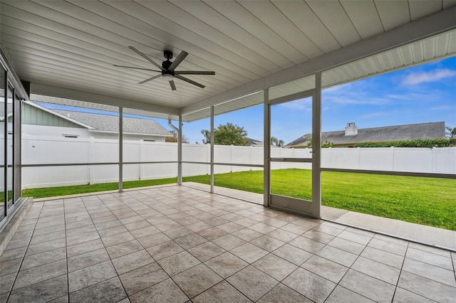 unfurnished sunroom with ceiling fan