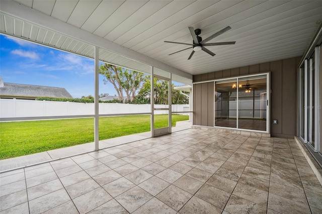 unfurnished sunroom with ceiling fan