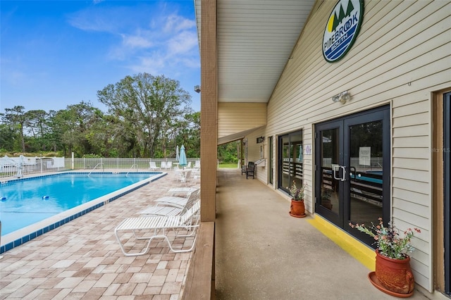 view of pool featuring french doors and a patio