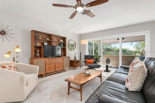 carpeted living room with ceiling fan