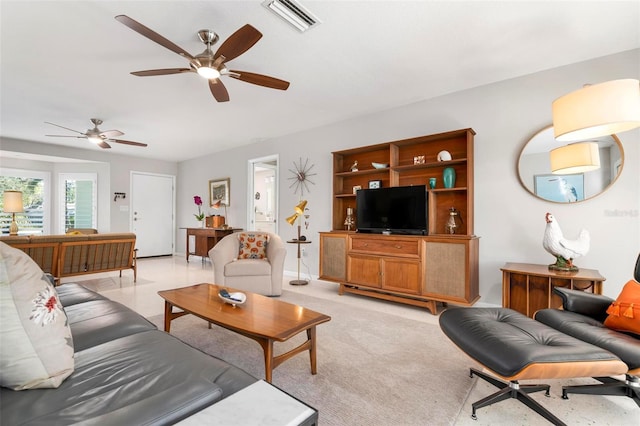 living room with ceiling fan and light colored carpet