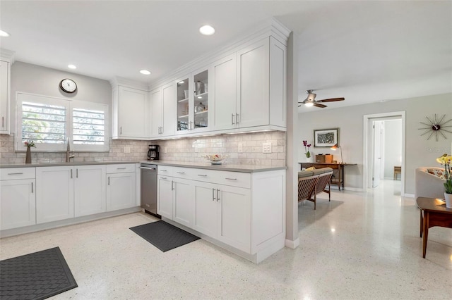 kitchen featuring tasteful backsplash, white cabinetry, ceiling fan, and sink