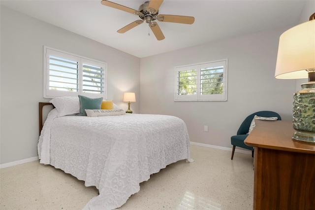 bedroom featuring multiple windows and ceiling fan