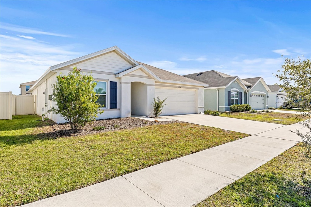 ranch-style home with a front lawn and a garage