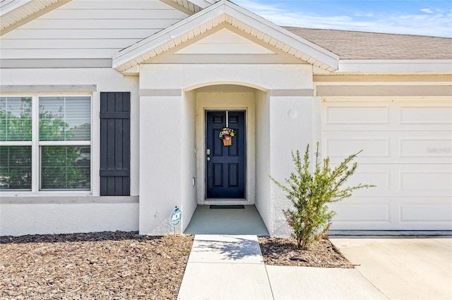 16766 Carlton Pond St, Wimauma, FL 33598 - view of exterior entry with a garage