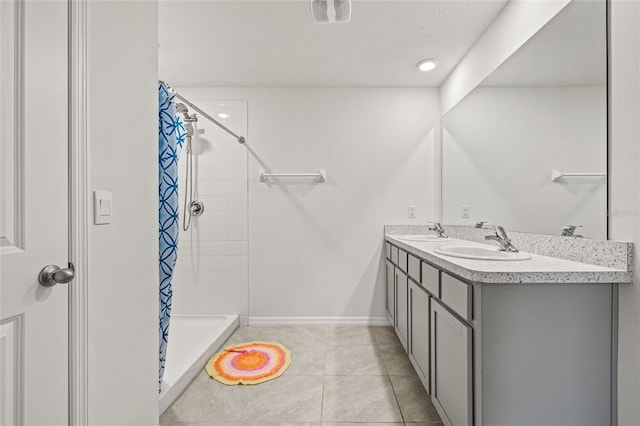 16766 Carlton Pond St, Wimauma, FL 33598 - bathroom with a textured ceiling, a shower with shower curtain, tile patterned floors, and vanity