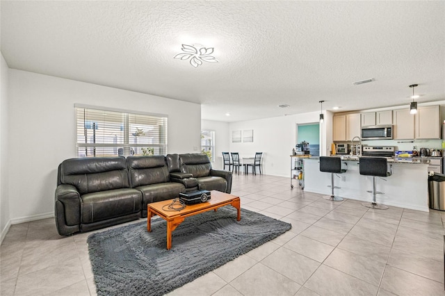 16766 Carlton Pond St, Wimauma, FL 33598 - tiled living room featuring sink and a textured ceiling