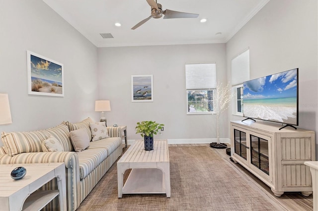 living room featuring crown molding and ceiling fan