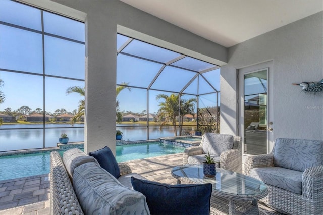 view of patio / terrace with a pool with hot tub, a lanai, an outdoor hangout area, and a water view