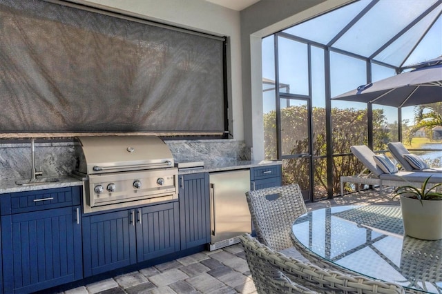 view of patio / terrace with area for grilling, a grill, and glass enclosure