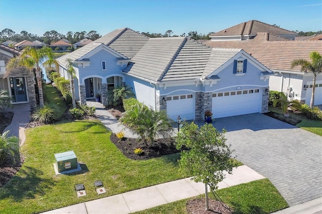 view of front of property with a garage and a front lawn